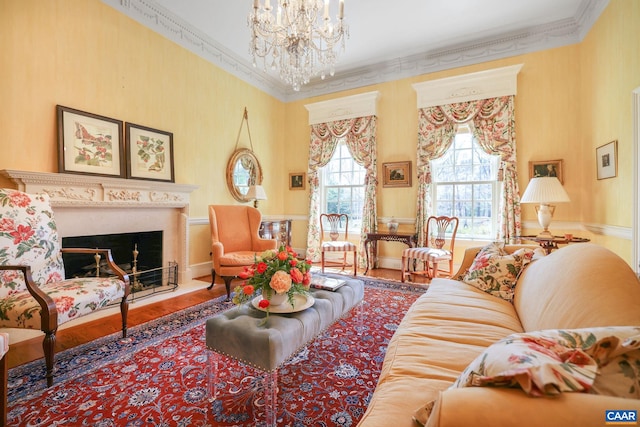 living room with ornamental molding, a notable chandelier, and hardwood / wood-style flooring