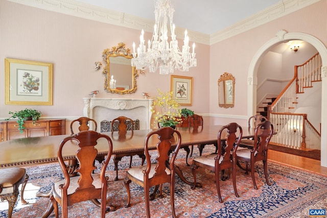 dining area featuring crown molding, a notable chandelier, and wood-type flooring