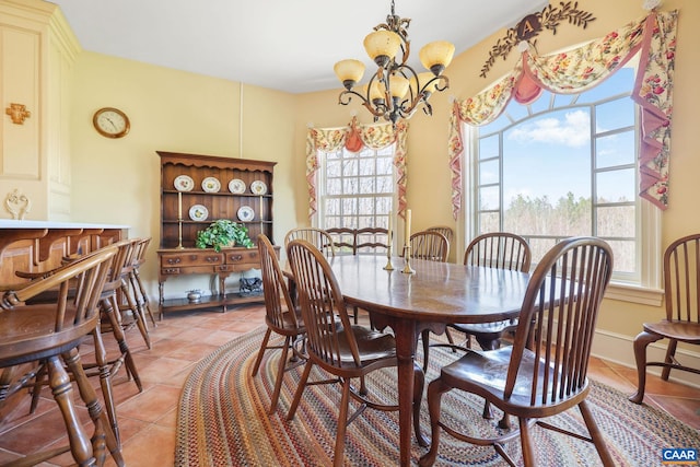 dining area with a notable chandelier and light tile floors