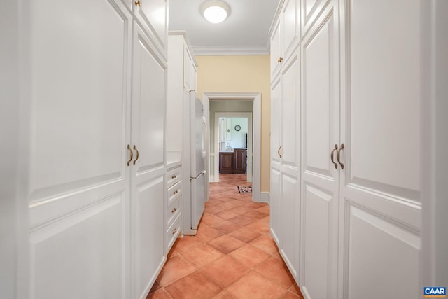 hallway with light tile floors and crown molding