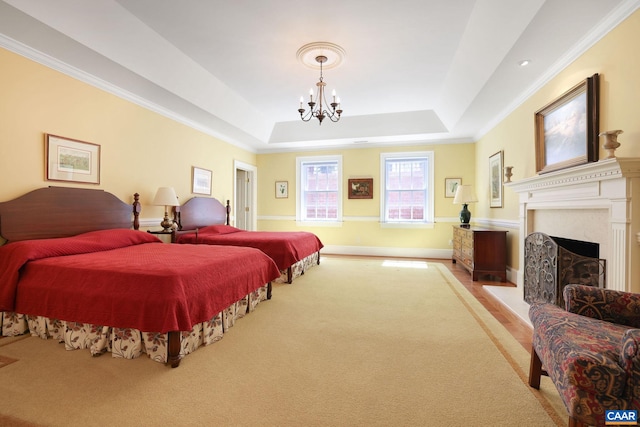 carpeted bedroom with crown molding, a notable chandelier, and a raised ceiling