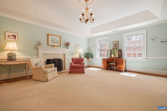 unfurnished room featuring an inviting chandelier, carpet floors, ornamental molding, and a tray ceiling