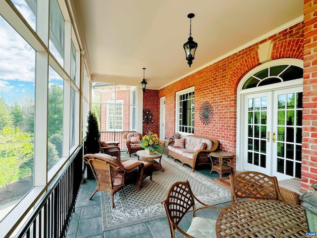 sunroom with plenty of natural light and french doors