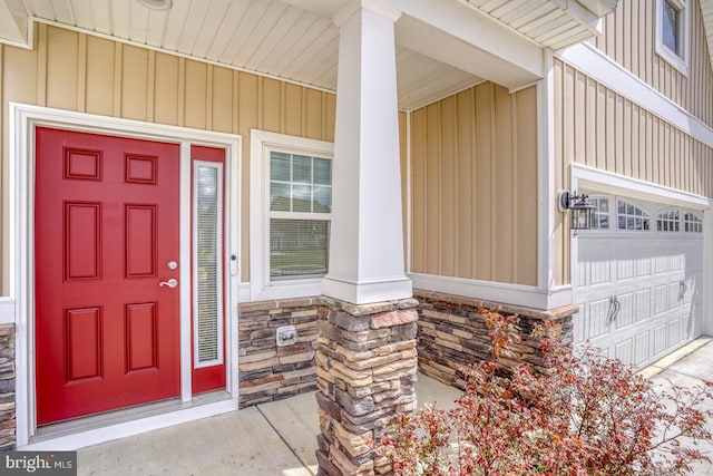 entrance to property with covered porch and a garage