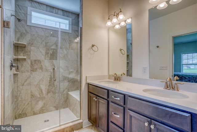 bathroom with an enclosed shower, double sink, and large vanity