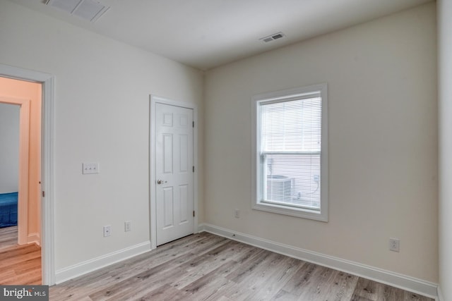 spare room with light hardwood / wood-style flooring