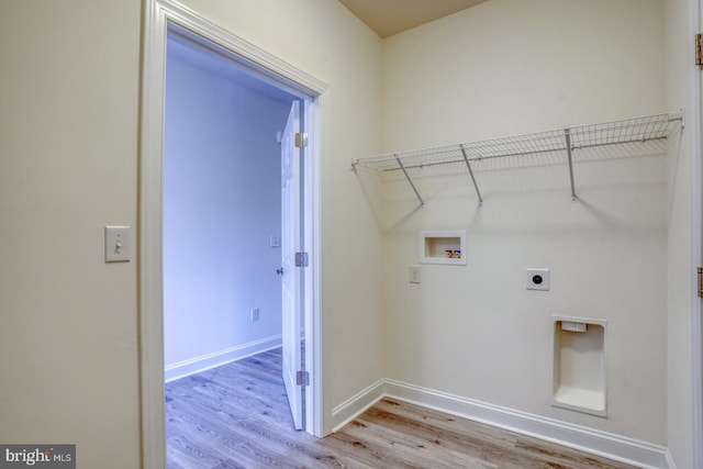 washroom with washer hookup, hookup for an electric dryer, and light hardwood / wood-style floors