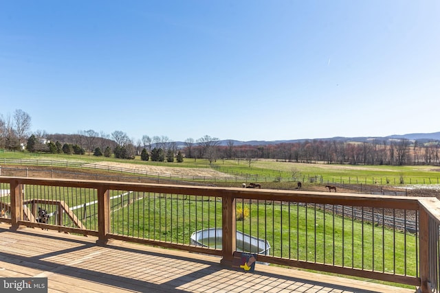 deck featuring a rural view and a yard