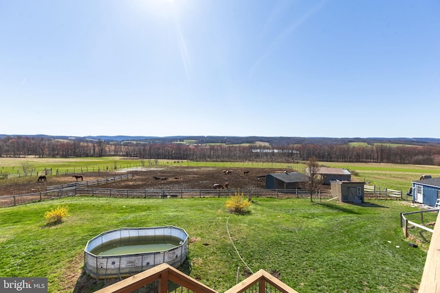 view of yard featuring a trampoline and a rural view