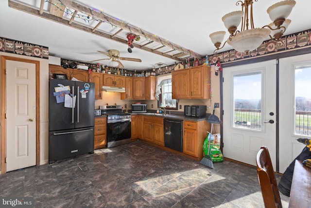 kitchen with decorative light fixtures, black appliances, ceiling fan, dark tile flooring, and sink