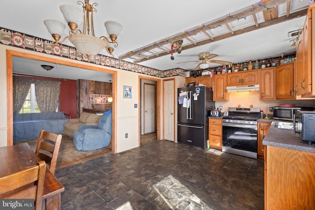 kitchen with hanging light fixtures, dark tile floors, stainless steel appliances, and ceiling fan