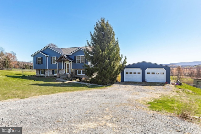 split foyer home featuring a front lawn and a garage