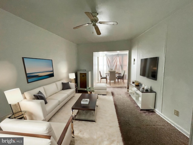 carpeted living room featuring ceiling fan