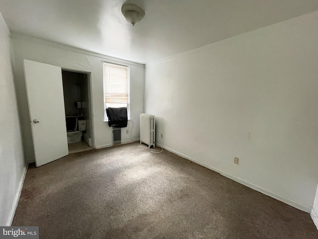 unfurnished bedroom with carpet and radiator