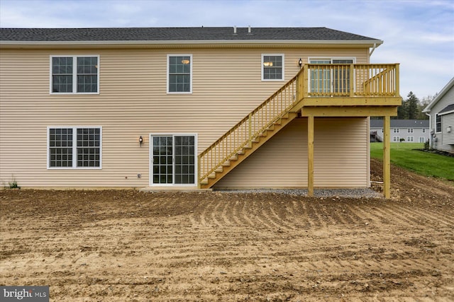 rear view of house featuring a wooden deck