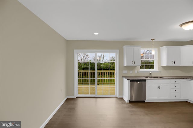 kitchen featuring white cabinets, sink, pendant lighting, dishwasher, and wood-type flooring
