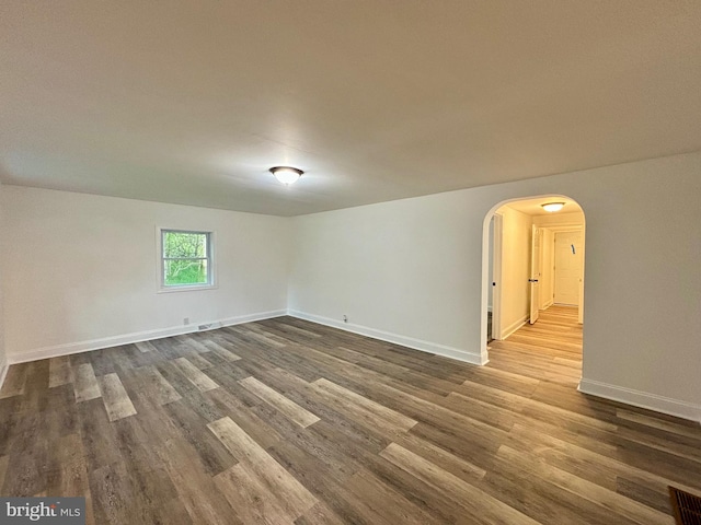 unfurnished room with dark hardwood / wood-style floors