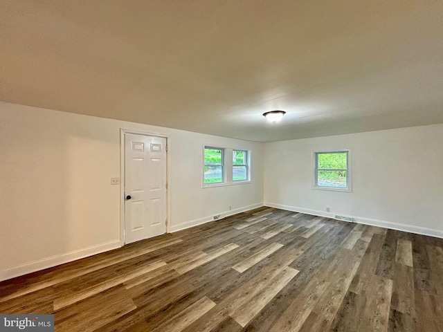 unfurnished room featuring dark hardwood / wood-style flooring