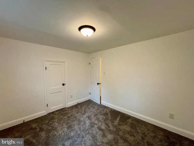 empty room with dark carpet