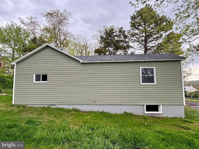 view of side of home featuring a yard