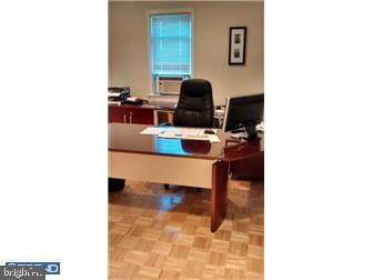 home office with cooling unit and light parquet flooring