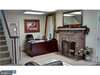 office area featuring a brick fireplace