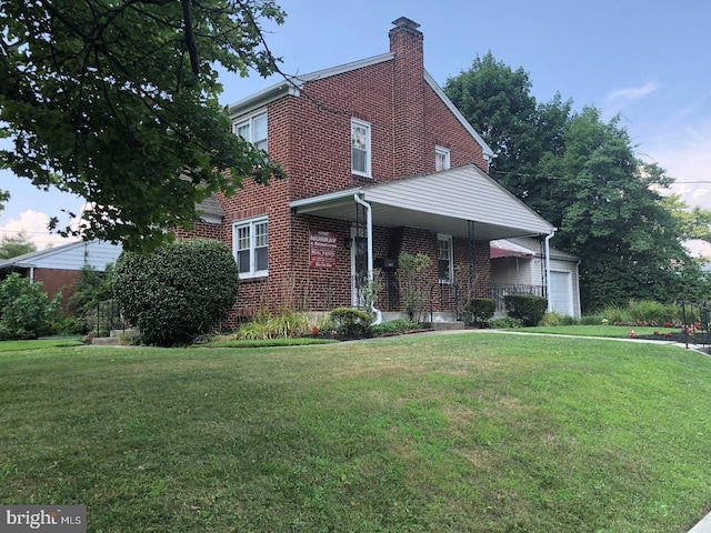 view of front of house featuring a porch, a garage, and a front yard