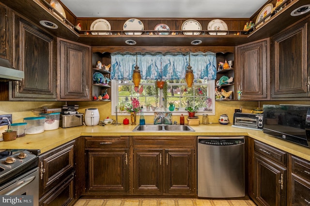 kitchen with stainless steel dishwasher, wall chimney range hood, sink, dark brown cabinets, and stove