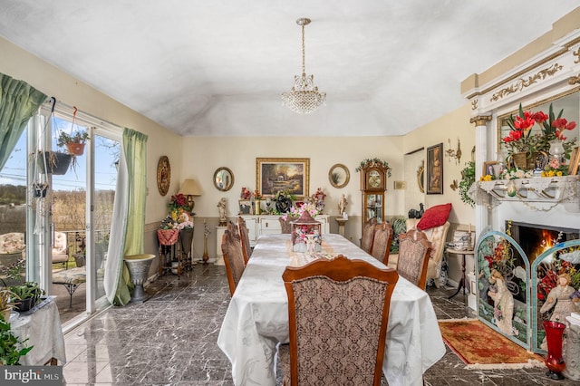 tiled dining space featuring a chandelier and a tray ceiling