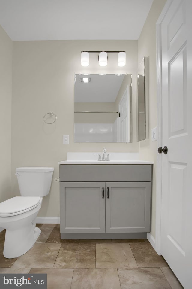 bathroom featuring vanity and toilet