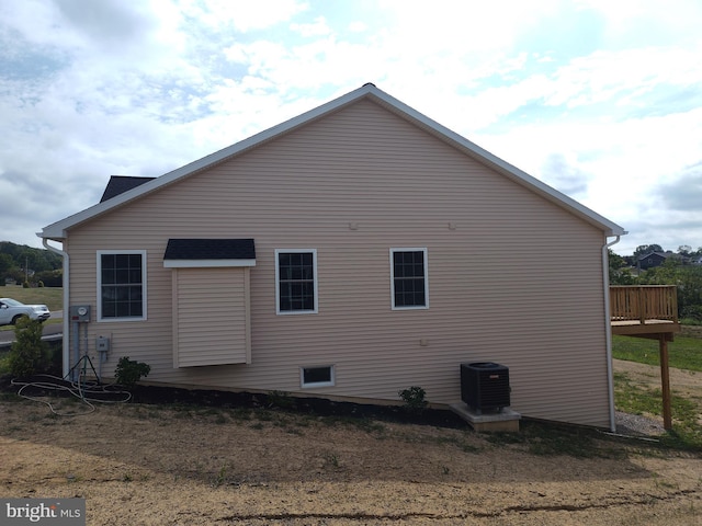 view of side of home featuring central AC unit and a wooden deck