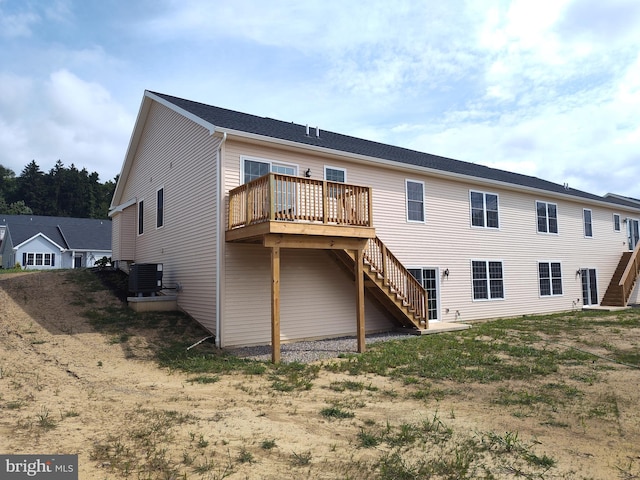 back of property with central AC unit and a deck