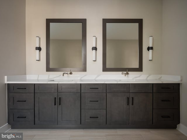 bathroom with double sink, large vanity, and tile flooring