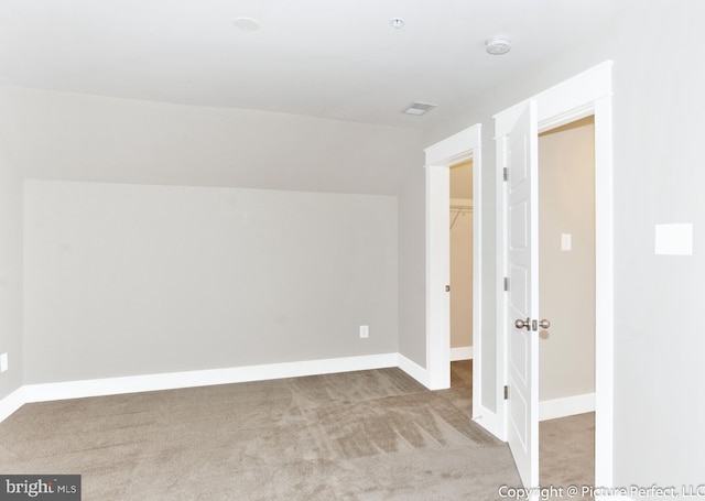 interior space with carpet flooring, a walk in closet, and a closet