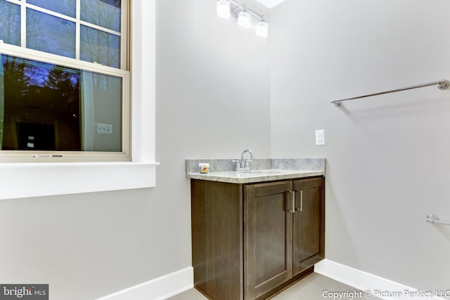 bathroom with vanity and tile flooring