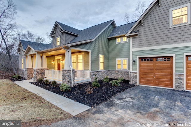 view of home's exterior featuring a porch and a garage