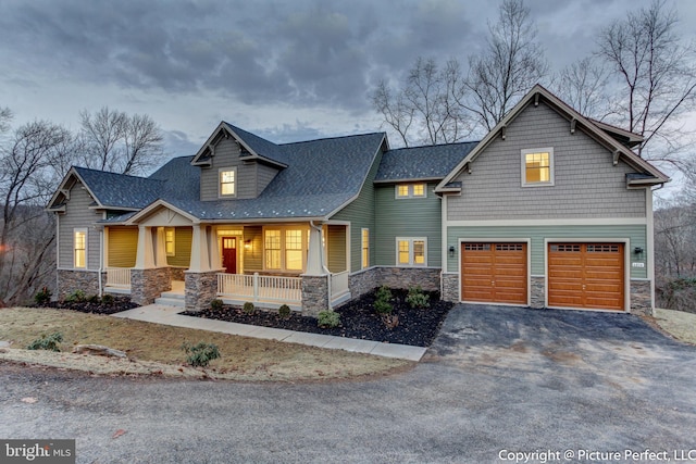 craftsman house with a porch and a garage