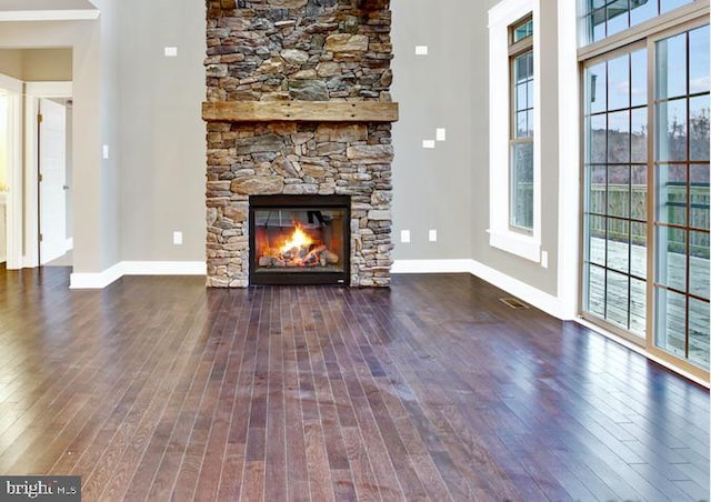 unfurnished living room featuring dark hardwood / wood-style floors and a fireplace