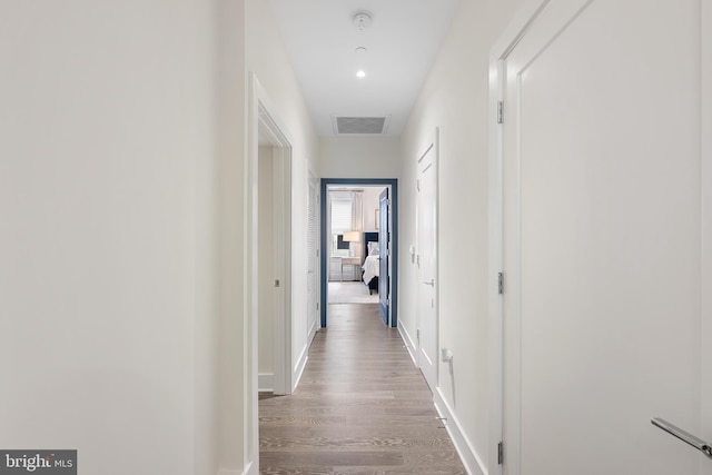 hallway with light hardwood / wood-style flooring