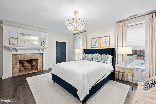 bedroom with a notable chandelier and hardwood / wood-style flooring