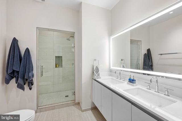 bathroom with walk in shower, toilet, tile floors, and dual bowl vanity