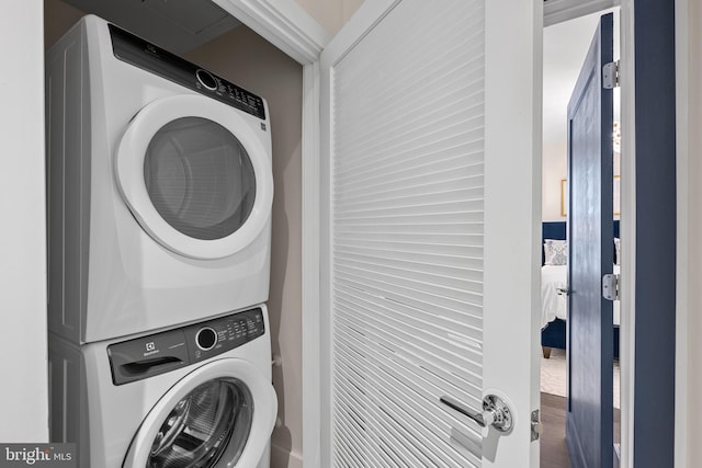 clothes washing area with stacked washer and dryer