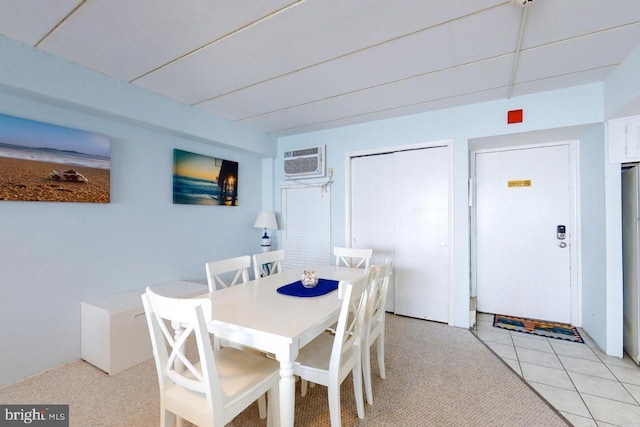 dining room featuring a wall mounted air conditioner, light tile flooring, and a paneled ceiling