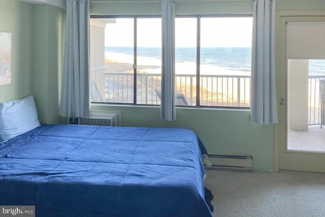 bedroom featuring a water view, baseboard heating, and carpet floors