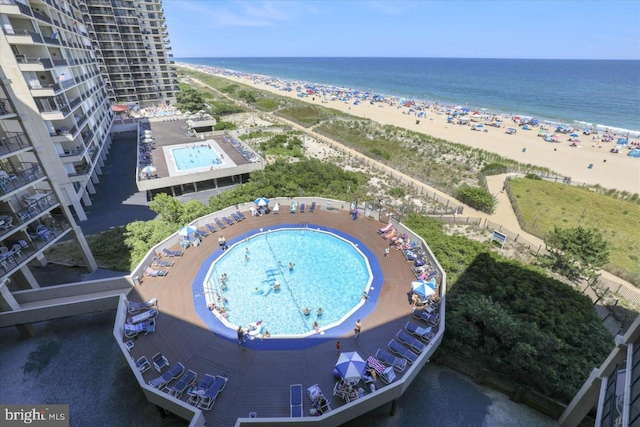 drone / aerial view with a water view and a beach view