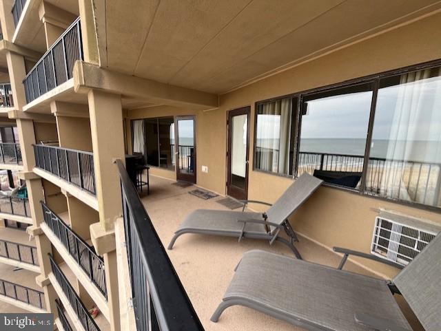 exterior space featuring a balcony and a water view