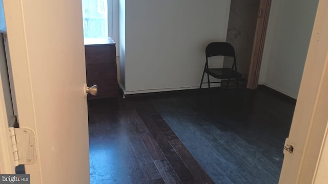 empty room with dark hardwood / wood-style flooring