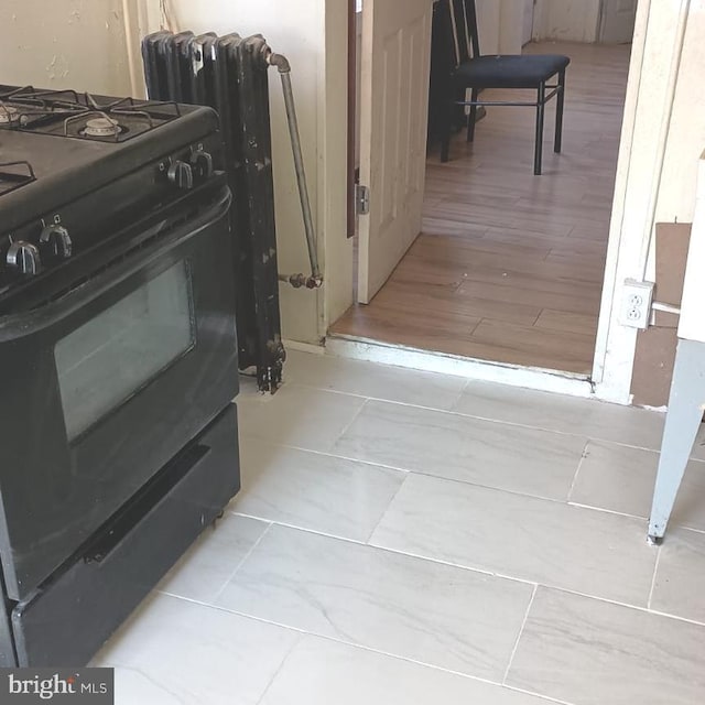 interior space with black range with gas cooktop and light wood-type flooring