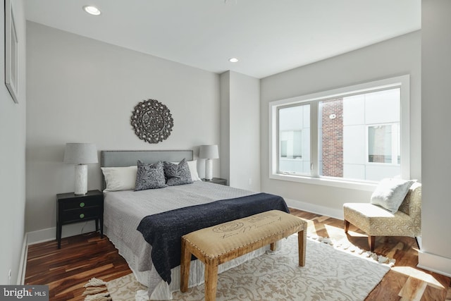 bedroom with dark hardwood / wood-style floors