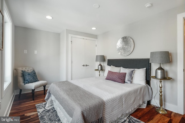 bedroom featuring a closet and dark wood-type flooring